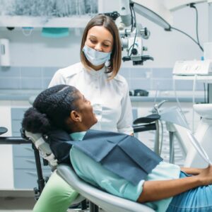 a patient speaks with her dentist about bridges