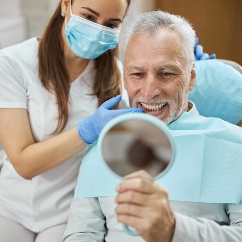 A patient sees his new dentures